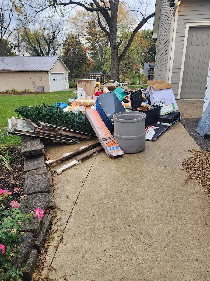 Dumpster being loaded with debris for Demolition Dumpster Rental in Norwood